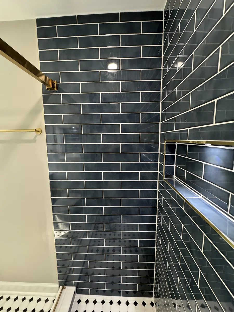 Finished bathroom view with shower and vanity