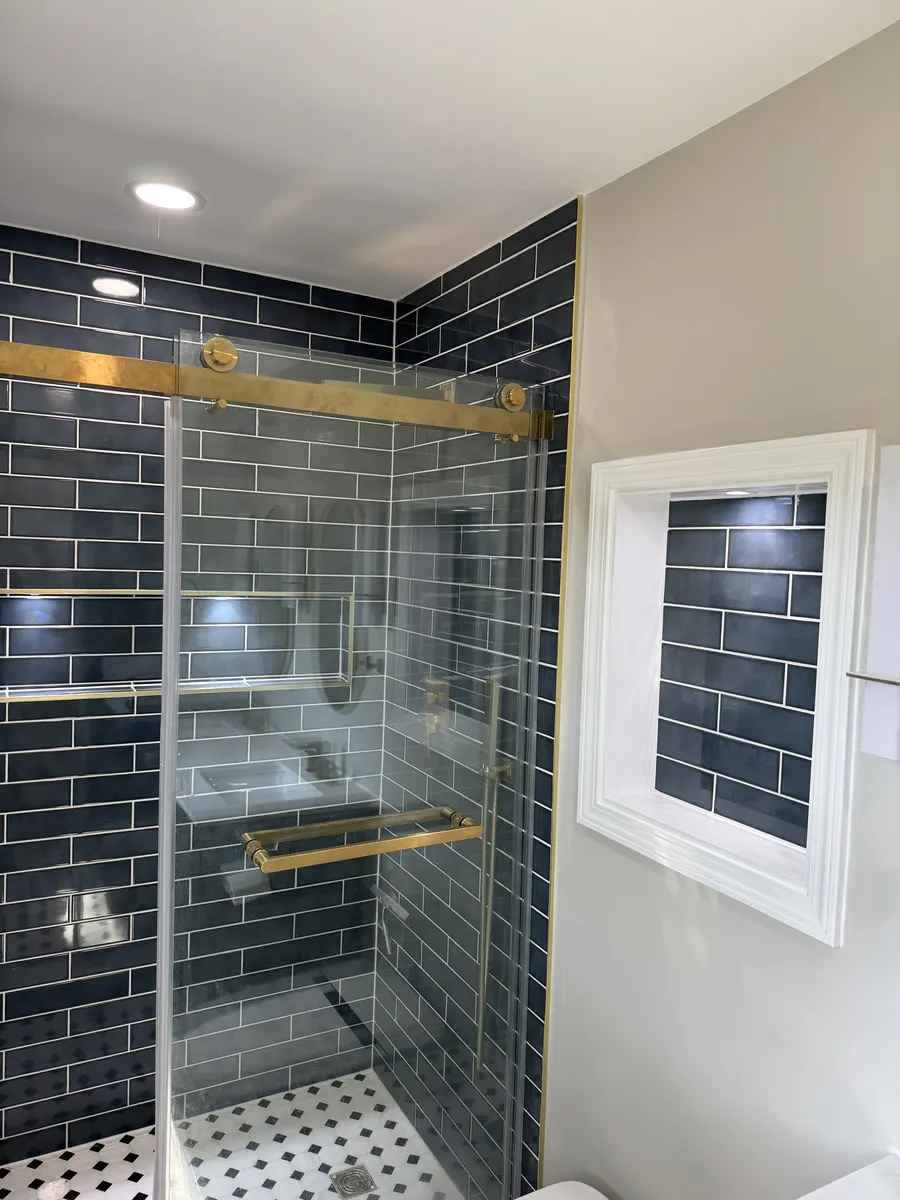 Finished bathroom floor tile with shower threshold