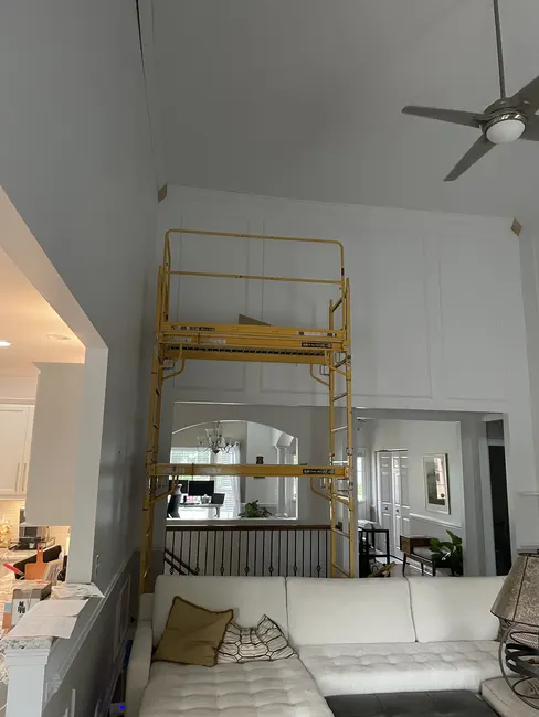 Scaffolding setup for crown moulding installation at height