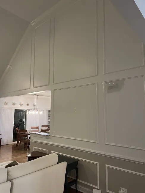 Finished room view with crown moulding and framed wall panels